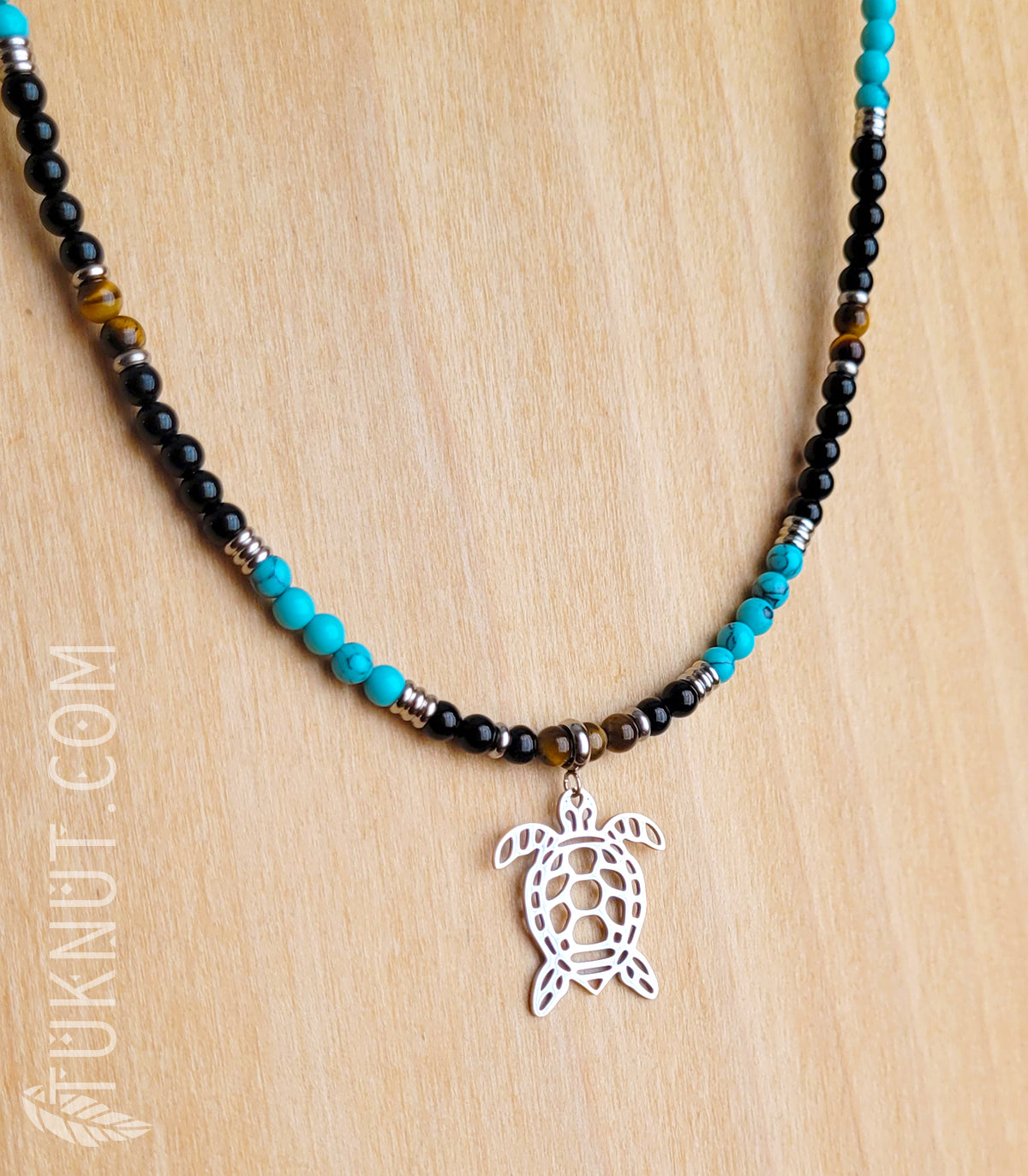 Collier d'inspiration autochtone (monté sur fil en acier inoxydable) avec turquoise, onyx et oeil de tigre, billes séparatrices, pendentif (tortue) et breloque (plume) en acier inoxydable (couleurs : noir, turquoise, brun et argent) TUKNUT