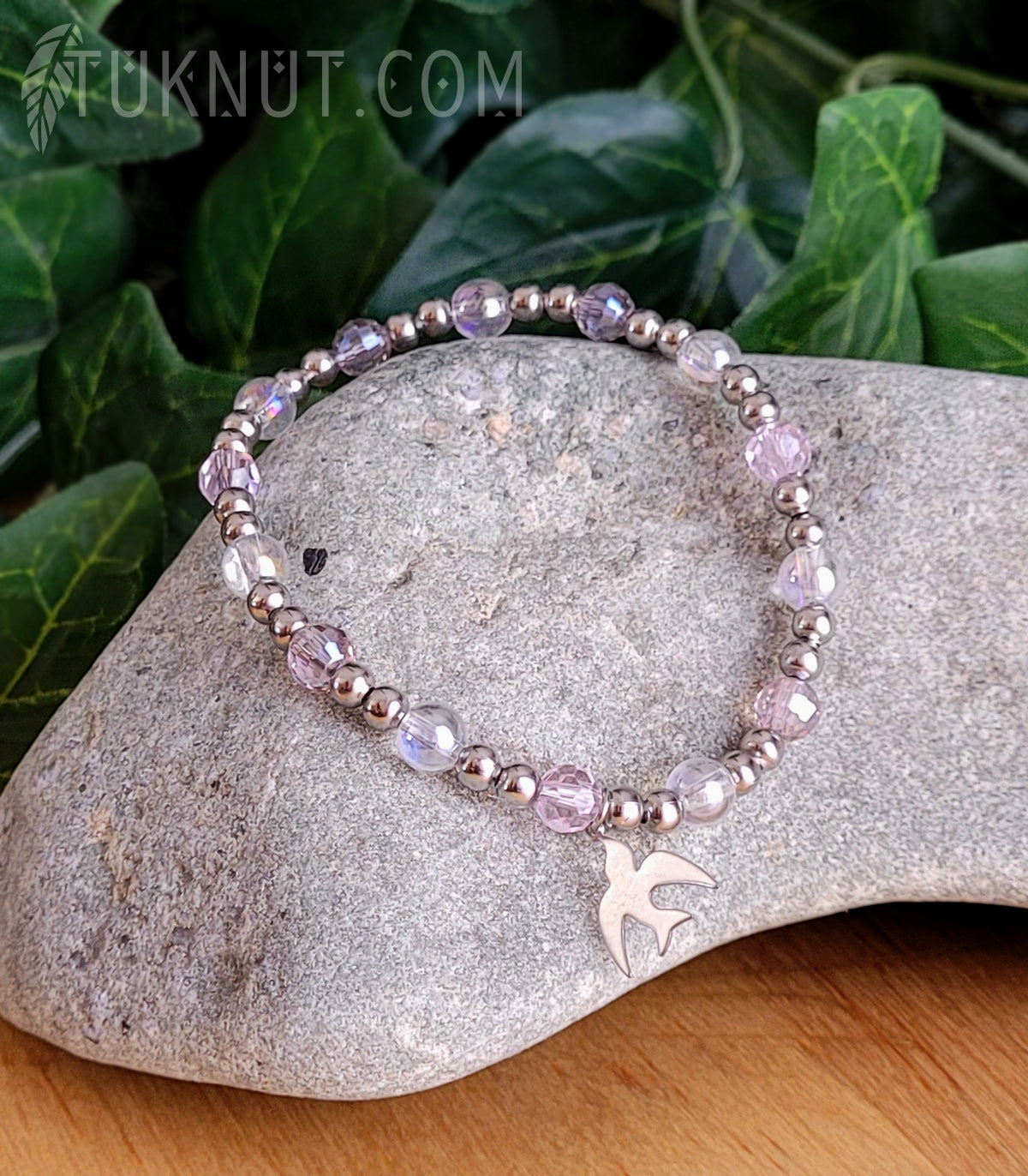 Bracelet extensible avec cristal, verre et breloque (oiseau) en acier inoxydable (couleurs : argent et rose) TUKNUT
