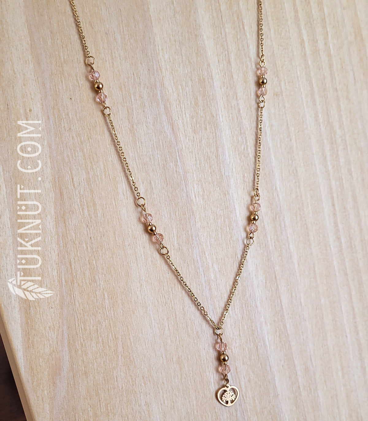 Collier d'inspiration autochtone avec pendentif (arbre de vie dans un coeur doré) en acier inoxydable avec cristal rose (couleurs : or et rose) TUKNUT
